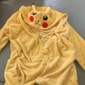 Pikachu “robe” - Pikachu cardigan, orginially a onesie but cut by the butt. Zipper like material left at the end. Cut in the front.