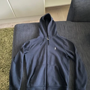 Full zip från Ralph Lauren - Riktigt snygg zip från ralph lauren. Passar dig mellan 165-170cm. Är i rätt så bra skick bortsett från snörena.