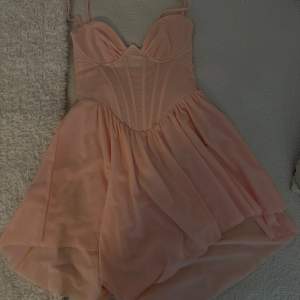 Oanvänd korsett klänning i en jättefin rosa färg med inbyggda shorts