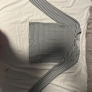 Randig lång armad tröja - Tröjan på bilden är randigt med öppna armar längst nere, skicket är bra och säljer för att jag inte använder den