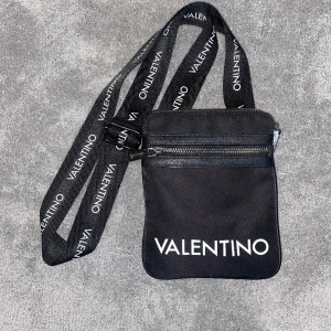 Valenetino väska - En liten valentino väska med långt axelremsband. Den är i bra skick. 
