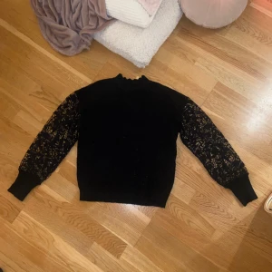 Tunn stickad tröja med spets på ärmarna - Bra skick, tröjan har lite mönster på den stickade delen