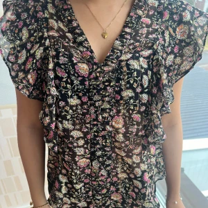 Blommig topp💕 - Säljer denna super söta toppen från mango i storlek xxs men passar mig som är xs. Man kan justera den i ryggen hur man vill att den ska sitta. Toppen är i mycket bra skick!💕