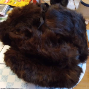 Pälsmössa med öronlappar stl 55. - Fin och välvårdad gammal pälsmössa med öronlappar i storlek 55 , Made in China..Arvegods. Hämtas i Skene alt skickas .