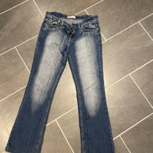 Jeans  - Jeans med mycket detaljer. Midjemått 90cm och längd 100cm. Har ansvänts många gånger men är i fint skick och är uppsydda 