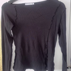 Svart topp - Svart topp från Weekday med sömdetaljer. Använd fåtal gånger, mycket bra skick. 