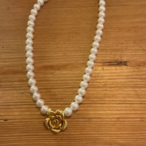 Halsband💗 - Pärlhalsband med en blomma💗  (Ej äkta) (något defekt spänne men går att knäppa)