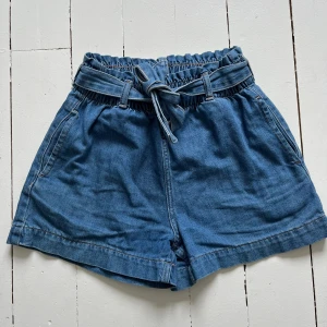 Jeansshorts  -  Jättesöta jeansshorts med band i midjan och fickor. Fint skick.