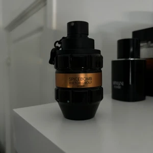 Spicebomb från Viktor & Rolf - En parfymflaska från Viktor & Rolf med namnet Spicebomb. Flaskan är svart med en kopparfärgad etikett och har en unik design som påminner om en handgranat.
