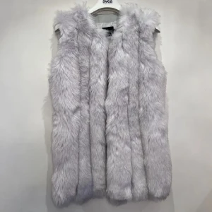 Ljusgrå pälsväst från Boohoo - Säljer en fluffig och lyxig ljusgrå pälsväst från Boohoo. Västen har en rak och loose passform med mjukt syntetpälsmaterial som ger en cool och trendig look. Perfekt att slänga över en hoodie eller långärmad tröja för extra värme och stil. Storlek XS men passar även en S. 