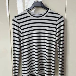 Randig långärmad tröja från Stylein - Snygg långärmad tröja från Stylein i storlek S med svartvita horisontella ränder. Mjuk och stretchig viskosblandning. 