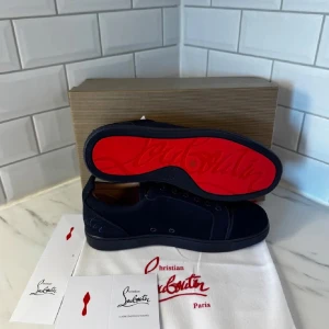 ‼️⚠️Christian Louboutin mörkblå SNABB REA - Snygga mörkblå sneakers från Christian Louboutin med klassisk röd sula och diskret broderad logga på hälen. Skorna har rund tå, snörning och är tillverkade i mocka och textil. Perfekta för dig som vill sticka ut med exklusiv stil och detaljer. SNABB REA ‼️⚠️