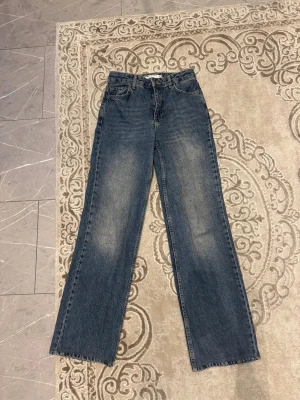 Straight fit jeans  - Blå mid waist-jeans i straight fitted-modell från Koton. Midjan är något rymlig, justerad av en skräddar!