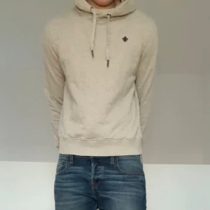 Beige Morris hoodie - Säljer en sjukt fet hoodie från Morris i beige. Den är i strl XS men passar mer som S. Hoodien är i väldigt bra skick eftersom den har varit väl omhändertagen. Hör gärna av er vid frågor eller funderingar!!