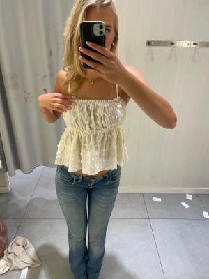 Vit volangig linnetopp med prickar - Supersöt vit linnetopp med tunna axelband och volangig nederdel. Skriv för fler bilder 🥰