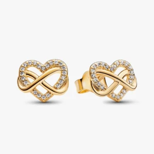 Guldiga hjärtformade örhängen med stenar - Snygga örhängen i guldton med hjärtform och oändlighetssymbol, dekorerade med glittrande stenar. Perfekta för att ge din look lite extra bling och romantisk vibe. Från Pandora, säljer även liknande halsband. Nyskick, dm om ni vill se bild på vanlig kamera. Nypris 799:-