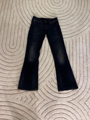 Bootcut jeans från Cheap Monday - Mörkblå bootcut jeans från Cheap Monday med klassisk femficksdesign och snygga slitningar. 