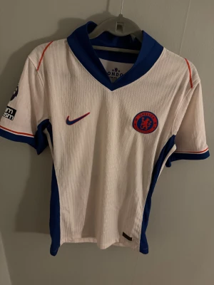 Chelsea FC vit bortatröja Palmer 20 - Säljer min vita Chelsea borta tröja med palmer nummer 20 där bak. Tröjan är helt ny och aldrig använd och har premier league badgen på armen. Storlek är S och priset kan diskuteras via snabb affär!!!