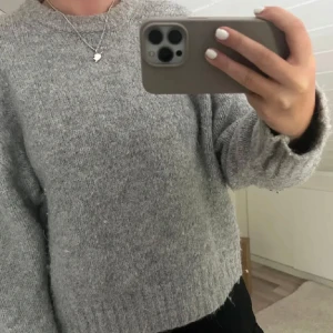 Grå stickad tröja från Zara - Mysig grå stickad tröja från Zara. Tröjan har en loose passform och långa ärmar. Enkel och stilren design som funkar till allt. (Bilderna är lånade från från personen jag köpte de av)