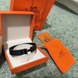 Armband  - Stilrent svart armband  med ikoniskt H-spänne. Kommer i original orange ask, dustbag och påse. Armbandet har en blank finish och är perfekt för dig som gillar lyxiga accessoarer med minimalistisk design. ✨