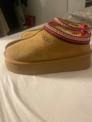 UGG tofflor - Säljer ett par helt nya  UGG  i beige mocka, storlek passar 35.5-36,36.5