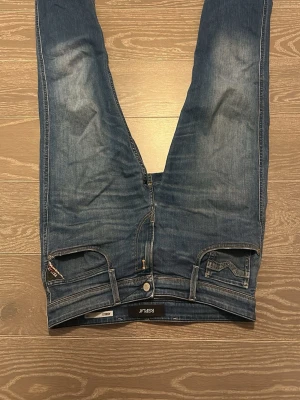 Replay Anbass slim fit jeans blå - Säljer ett par Replay Anbass slim fit jeans i klassisk blå tvätt. De är använda med försiktighet och är nästan nya förutom det röda snöret som sitter på vänster sida av jeansen, men det går enkelt att lösa. Det är storlek 30/34
