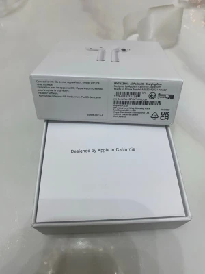 Apple AirPods med laddningsetui - Säljer ett par vita Apple AirPods med laddningsetui. De är trådlösa in-ear hörlurar i klassisk Apple-design, tillverkade i blank plast. Perfekta för musik, samtal och smidig anslutning till iPhone och andra Apple-enheter. Laddningskabel medföljer.