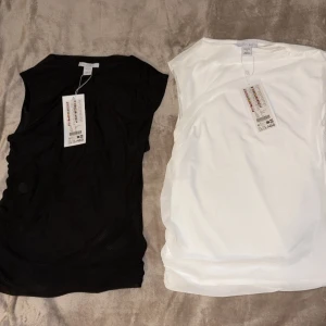 Svart och vit ärmlös topp från Amisu  - Två stilrena ärmlösa toppar från Amisu en i svart och en i vitt. Båda har fint passform och rund halsringning. Perfekta att matcha med jeans eller kjol för en clean look. Materialet är mjukt och lätt, vilket gör dem sköna att bära hela dagen. Priset går att diskuteras🎀