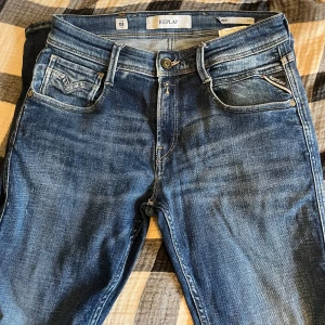 Blå Replay Anbass jeans herr 28/32 - Snygga blå Replay Anbass jeans med klassisk femficksdesign och tydliga slitningar. Jeansen är sparsamt använda och iprincip i nyskick, inga defekter! Passar w27-w29 eftersom att de är stretch.