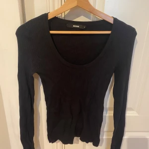 Svart ribbad långärmad tröja BikBok - Svart långärmad tröja från BikBok i storlek S. Tröjan är ribbad och har en rund, djup ringning. Perfekt basplagg som är lätt att matcha med allt. Sitter tajt och har en klassisk, stilren look.