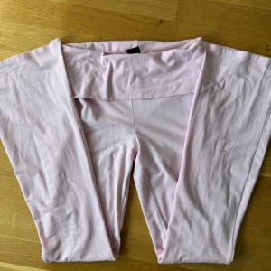 Ljusrosa bootcut byxor Gina Tricot - Supersköna ljusrosa bootcut byxor från Gina Tricot i mjukt bomullsmaterial. Hög midja och stretchig passform som sitter snyggt över höfterna och släpper ut vid benen. Perfekta för en chill och trendig look.🌸✨