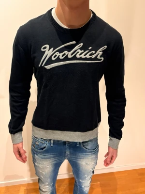 Woolrich Tröja - Woolrich tröja med tryck, fint skick och bra material. Strl M men sitter S. Modellen på bilden är 184 och väger Ca 70 kg. Tveka inte på att höra av er 🤝/ N&V