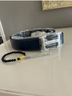 Mörkblått H bälte  - Säljer mitt herrmes bälte 115cm helt nytt. Armband ingår. Hör av er vid frågor och funderingar 