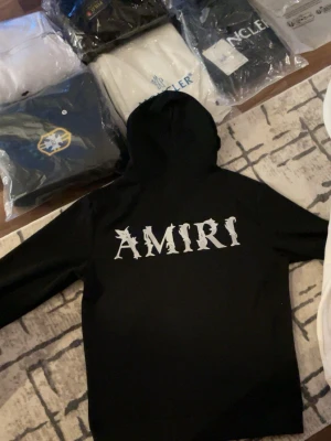 Amiri Hoodie - Säljer en helt ny Amiri hoodie som är i storlek M, berätta hur lång du är och hur mycket du väger så att jag svarar om den passar eller inte.. Passar perfekt inför vintern, håller dig stilig och varm. Om du vill köpa den vita så finns den i min profil. Passa på och köp❄️