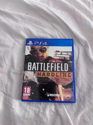 Battlefield Hardline PS4 - Battlefield Hardline till PlayStation 4 i bra skick. Komplett med fodral och skiva, inga synliga repor eller skador. Ett actionfyllt FPS-spel där du väljer sida mellan polis och brottsling. PEGI 18. Perfekt för dig som gillar intensiva multiplayerspel.Vill man köpa flera st sv spelen så är det bara o kontakta 