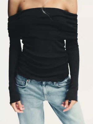 Svart offshoulder topp - Trendig svart offshoulder topp med långa ärmar och åtsittande passform. Toppen har en bred kant över axlarna som ger en snygg siluett. Perfekt att styla med jeans eller kjol för en cool look.