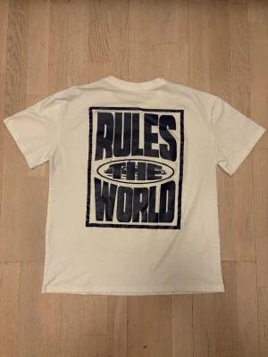 T shirt Rules the World - Worn quite a few times Little holes (not  noticeable) as you can see in the last image Print a bit deteriorated (second to last image)