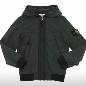 Stone Island Jacka  - Strl. 14 year / 170 Non-detachable hood Front zip closure  Nypris 4995kr  Knappt använd .  Betalning sker vid upphämtning och med  Swish .
