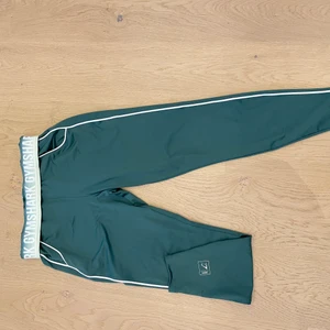 Gymsshark byxor - Gröna gymsshark byxor i storlek M säljes pga fel storlek. Midjan går att välja hur man vill ha den! Super material och följsam byxa. Köparen står för eventuella fraktkostnader