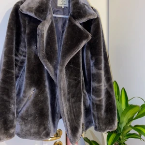 Faux fur coat  - En fin faux fur coat i grå, storlek M. Den är lite oversize och sitter bra (Kan passa storlek L också). Den är inte använd många gånger men en bit av tyget på insidan har rivits upp. Det syns inte när man har på sig den och går lätt att sy upp. Annars är jackan i bra skick, skulle nog säga att jackan är ganska varm. Den passar till hösten men det skulle kunna funka även på vintern om man har något tjockt under. 