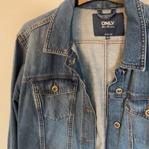 Jeansjacka från ONLY - Superfin jeansjacka i mellanblå från ONLY i storlek 42. Lite längre i modellen och finns inte längre att köpa i butik. Säljer för 149kr, nypris 449kr. Priset kan diskuteras, först till kvarn!