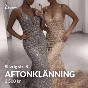 Aftonklänning silver strl 36/38 - En silvrig/glittrig lång aftonklänning! Den är bara använd en gång och köpt för 5400 kr! Bra skick. Den är i storlek 8, dvs en 36/38 vanligtvis. Klänningen har en öppning baktill. Vid fler bilder kan du bara höra av dig! 💖