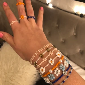 Pärlarmband och ringar - Säljer pärlarmband och ringar som jag gjort själv💘💘 Köp dem som finns på bild eller kom med egna förslag på färg och design:) Kika även in mina andra annonser för fler smycken🥰 Pris för en av ringarna på bilden: 15kr, pris för en ring med bara små pärlor: 10kr, pris för ett armband med bara små pärlor: 25kr, pris för ett armband med små och stora pärlor: 30kr, pris för ett armband med egengjorda blommor och små pärlor: 40kr, pris för ett armband med bara egengjorda blommor: 45kr. Frakt: 13kr