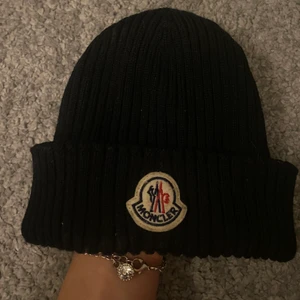 Moncler mössa!!  - Moncler mössa köpt på NK. Äkta! Knappt använd och det är också därför jag har valt att sälja den. Sitter riktigt snyggt! Nypris: 1700kr
