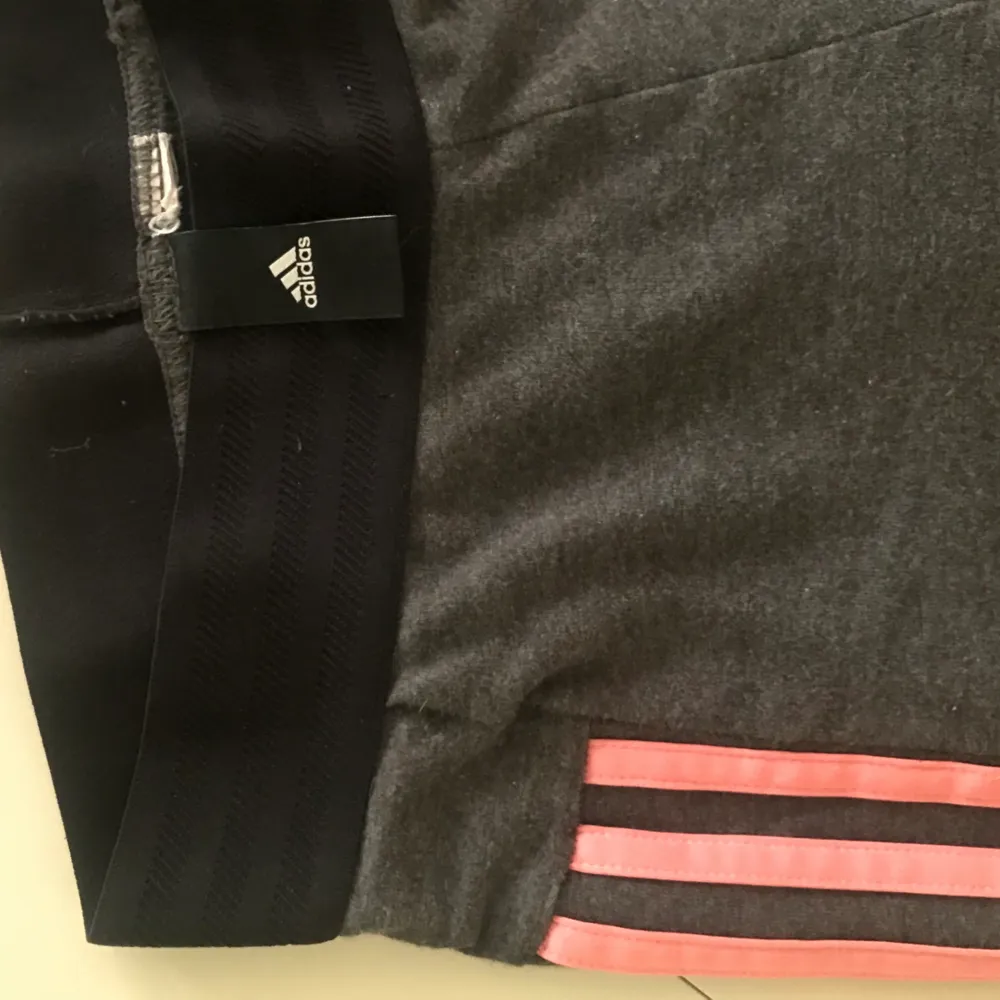 Gråa tights från Adidas i storkek XS. Väldigt stretchiga med rosa streck💕 Väldigt bra skick! Finns i stockholm, kan skickas💕. Jeans & Byxor.