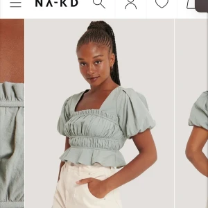 Mintgrön blus - Säljer denna söta korta blusen med puffärmar från NA-KD💕. Har använts 1 gång så är fortfarande i nyskick.  Köptes för 299 kr men säljer för 190 kr. Säljer då den inte kommer till användning🦋