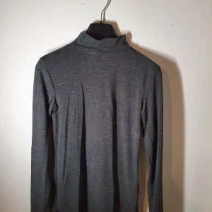 Mörkgrå polotröja - Säljer en mörkgrå polotröja från gina tricot i storlek XS. Tröjan har lite ludd och mitt pris är 40kr. Men i övrigt är tröjan i gott skick.