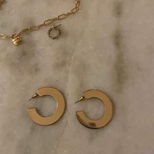 Guldörhängen i form av stora ringar/hoops! De är ”platta” vilket gör att de sticker ut lite från vanliga ringformade örhängen✨🤎 skriv för bilder etc!