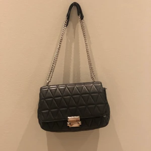 Michael kors väska - Säljer min älskade svarta michael kors väska sjukt snygg och modern med silverkedja kan både användas som crossover väska eller axelremsväska