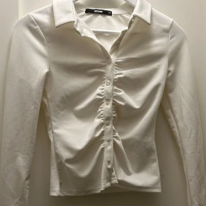 Vit Topp  - Vit långärmade topp i storlek XS. Använd 1 gång men i superbra skick. Sitter tajt och den är stretchig. 